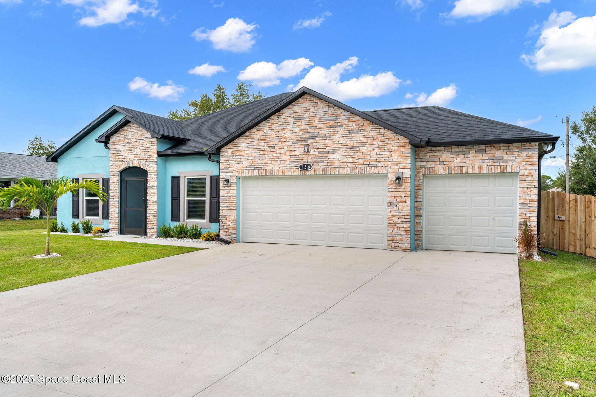 1125 Satin Road Palm Bay, FL 32908 - Photo 3 of 26 a view of a house with a yard and garage