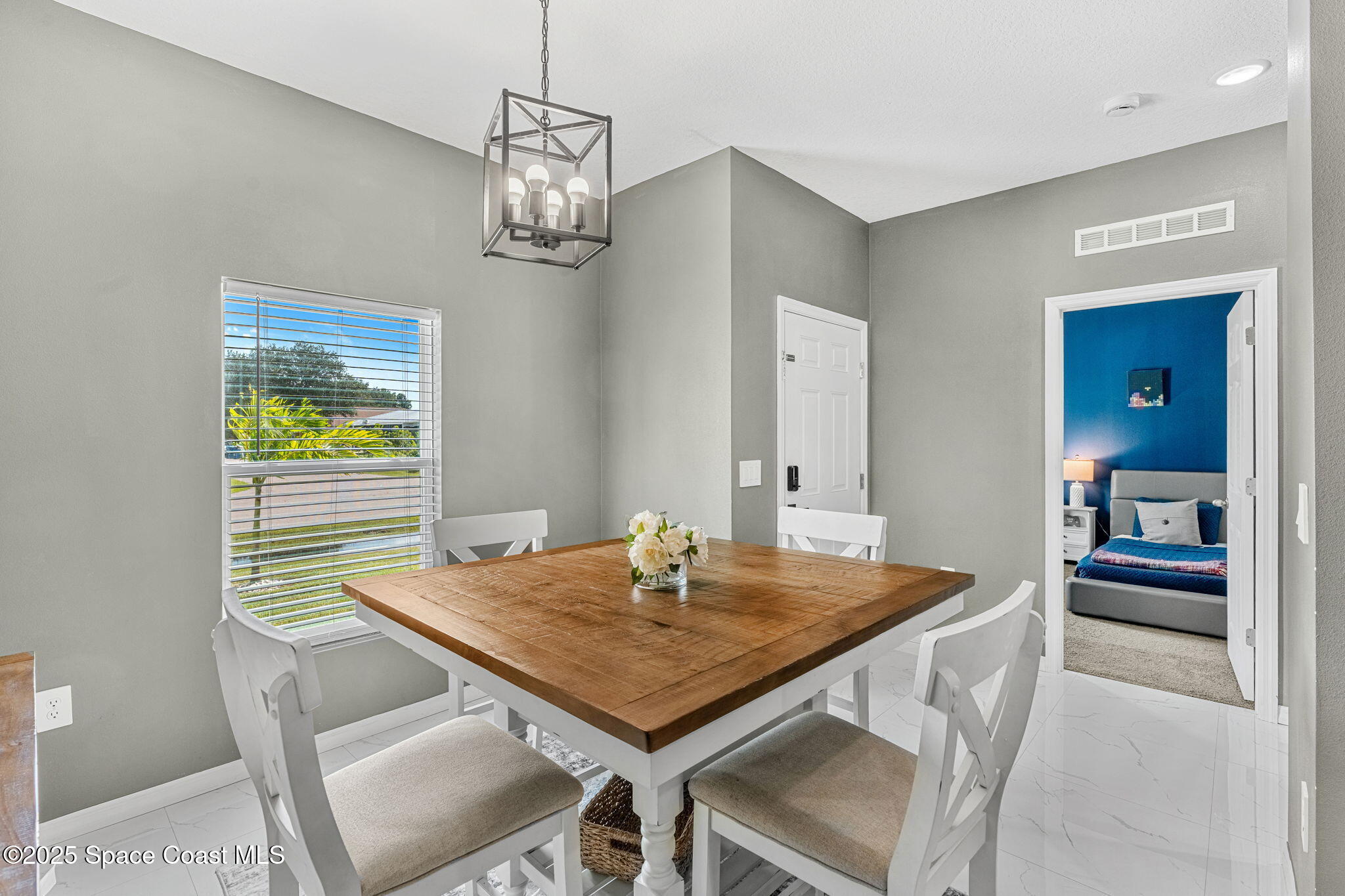 1125 Satin Road Palm Bay, FL 32908 - Photo 6 of 26 a view of a dining room with a table and chairs
