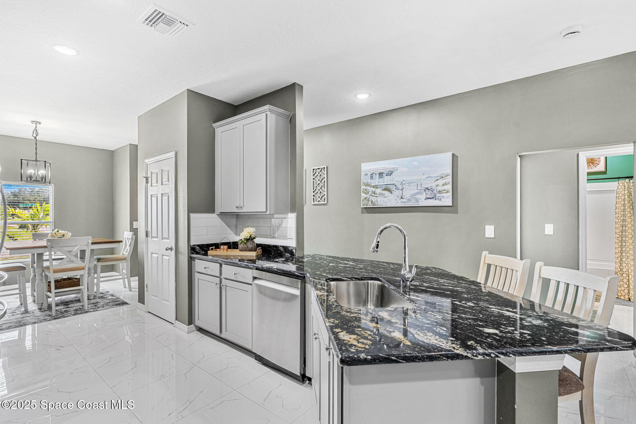 1125 Satin Road Palm Bay, FL 32908 - Photo 10 of 26 a kitchen with granite countertop a stove and cabinets