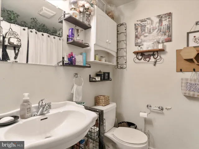 a bathroom with a sink mirror and toilet