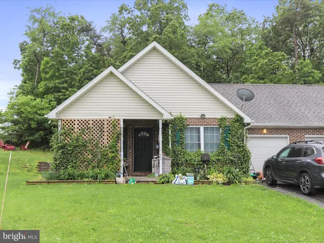 a view of a house with a yard and a garden