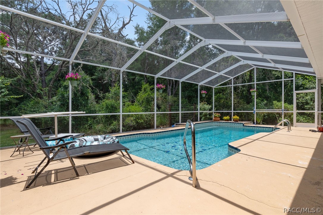 2460 West Pine Ridge Boulevard Beverly Hills, FL 34465 - Photo 39 of 47 a view of a backyard with a wooden deck and swimming pool