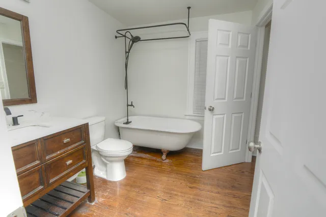 a bathroom with a toilet sink and shower