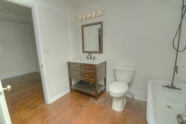 a bathroom with a toilet sink and mirror
