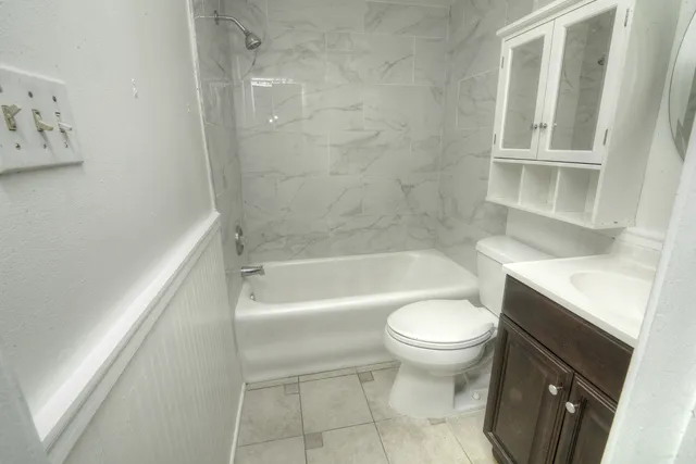 a bathroom with a bathtub and a toilet