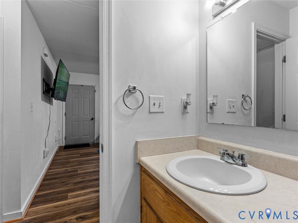 14175 Lebanon Road Disputanta, VA 23842 - Photo 33 of 60 Bathroom vanity with a white oval sink, chrome fau