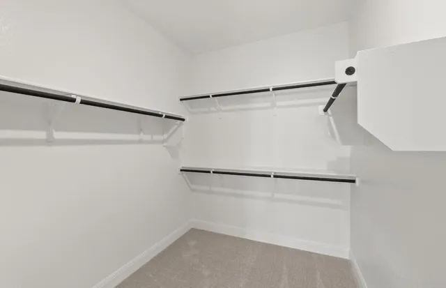 a spacious bathroom with a double vanity sink a large mirror and shower