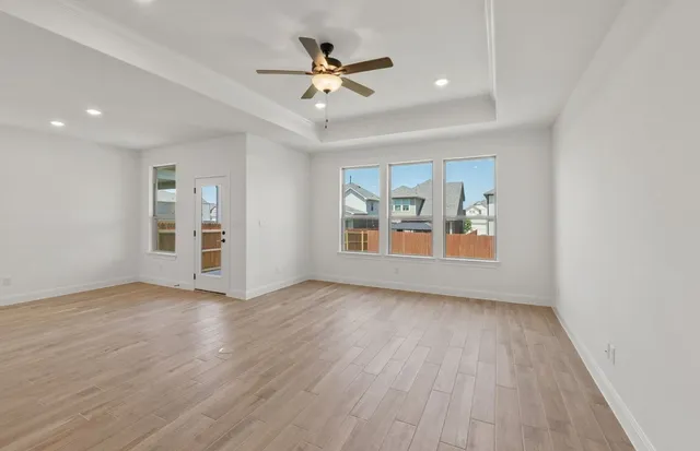 wooden floor in an empty room with a window