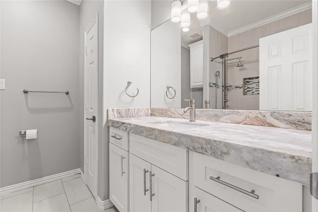 a bathroom with a granite countertop sink mirror and vanity