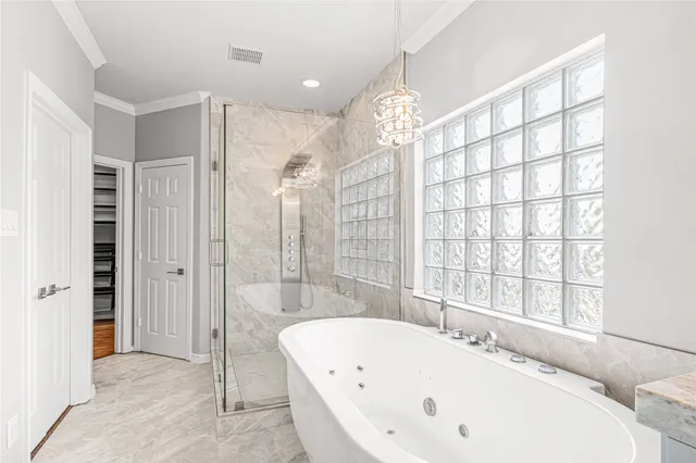 a bathroom with a granite countertop sink mirror and a bathtub