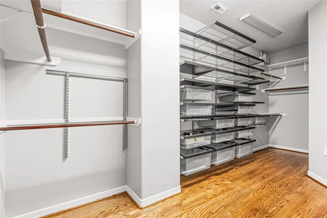 a view of walk in closet with empty racks