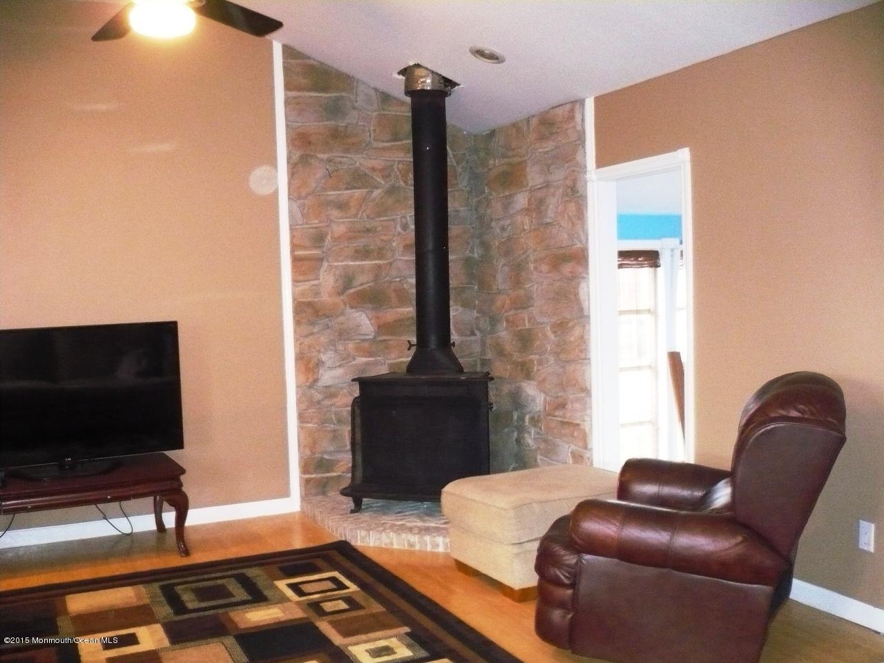 319 Stinson Road Brick, NJ 08723 - Photo 2 of 11 a living room with furniture and a flat screen tv
