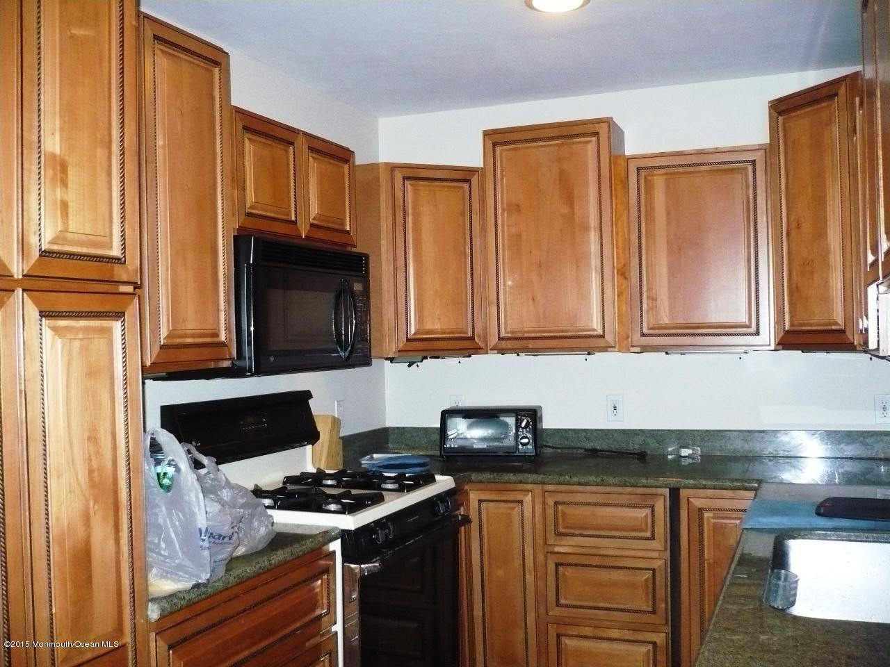 319 Stinson Road Brick, NJ 08723 - Photo 4 of 11 a kitchen with stainless steel appliances granite countertop a stove and a microwave