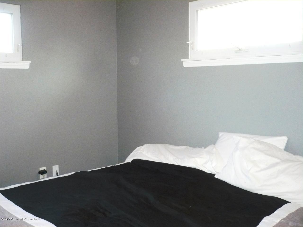 319 Stinson Road Brick, NJ 08723 - Photo 8 of 11 a bed sitting in a bedroom next to a window