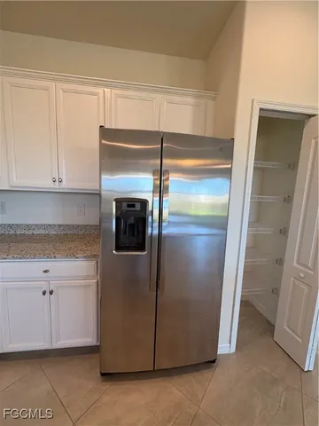 a kitchen with a refrigerator and cabinets