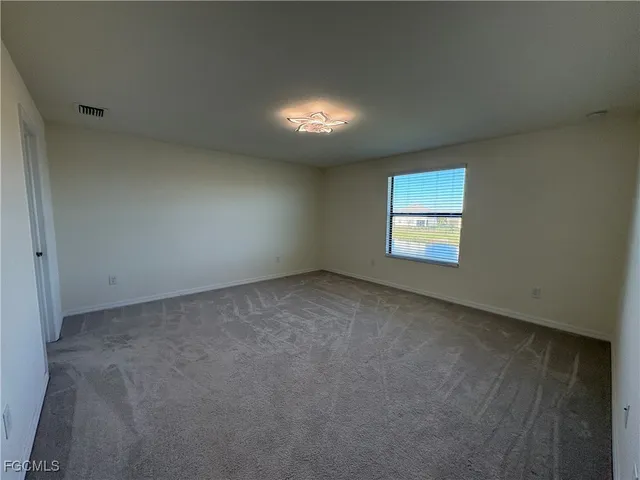an empty room with a empty space and windows