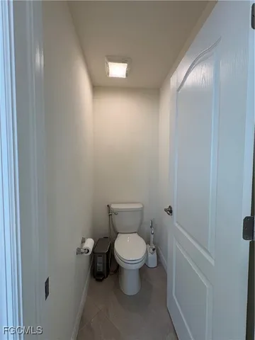 a white toilet sitting next to a shower