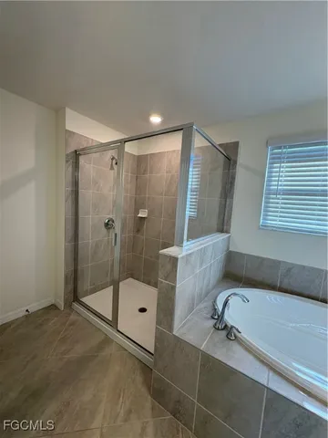a bathroom with a shower and a bathtub