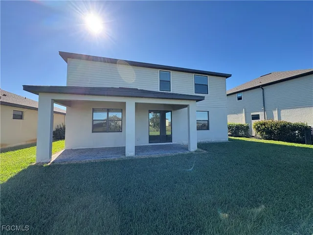 a view of an house with backyard space and balcony