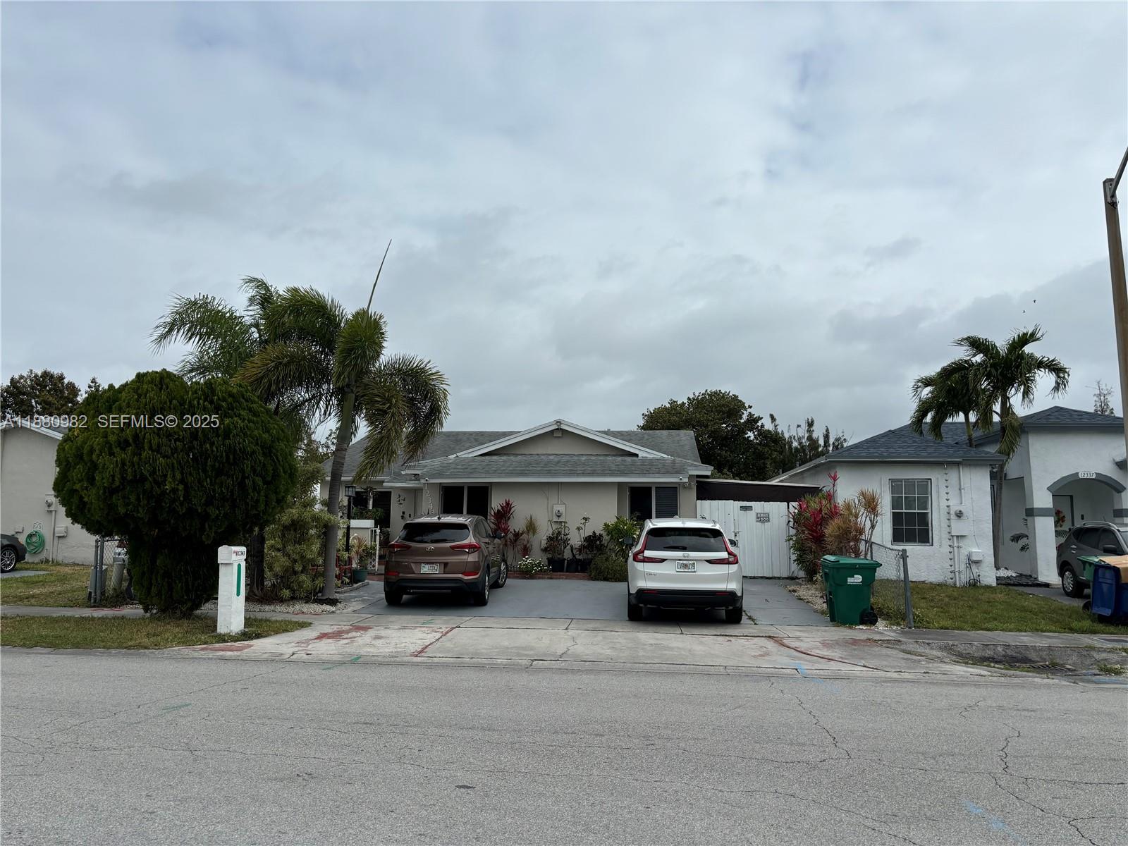 a car parked in front of a white house