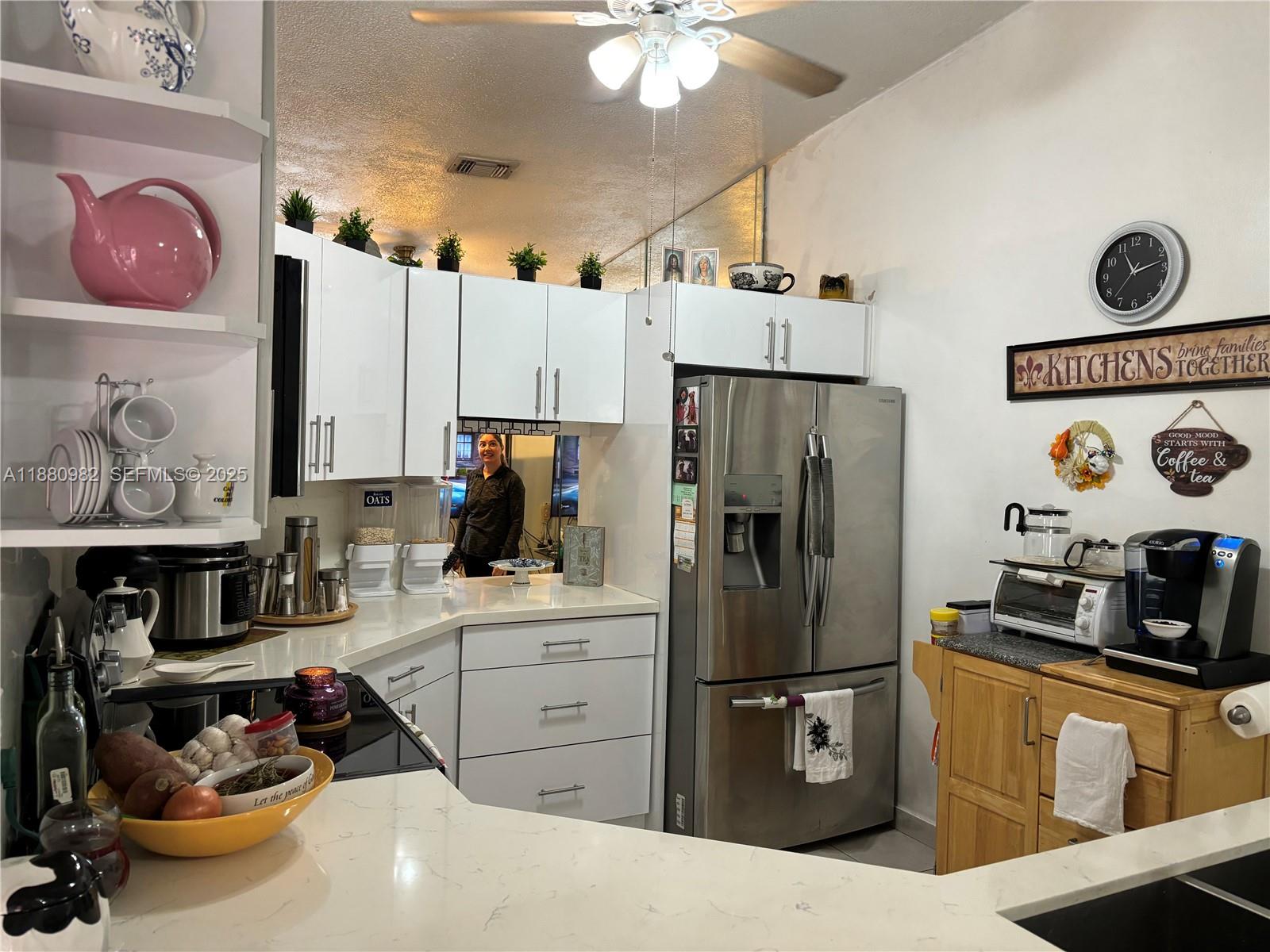 12343 Southwest 195th Terrace Miami, FL 33177 - Photo 14 of 45 a kitchen with stainless steel appliances a refrigerator sink and cabinets