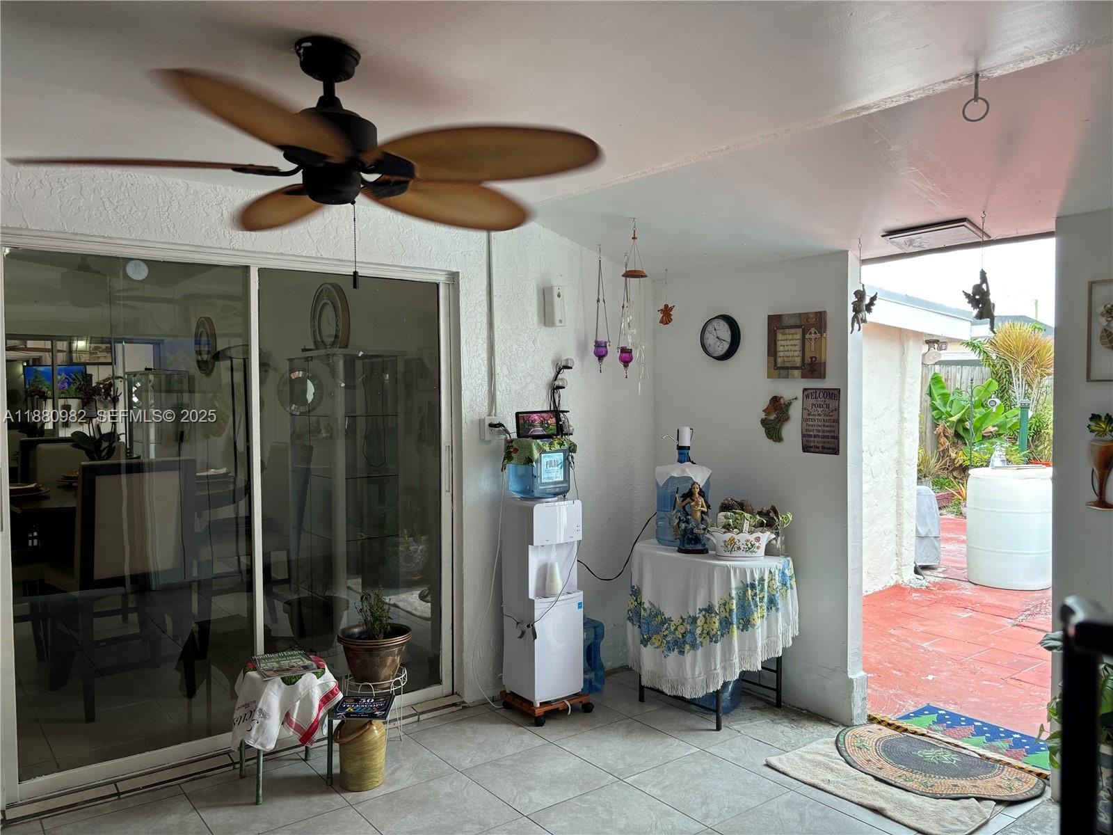 12343 Southwest 195th Terrace Miami, FL 33177 - Photo 18 of 45 a room with furniture and a chandelier