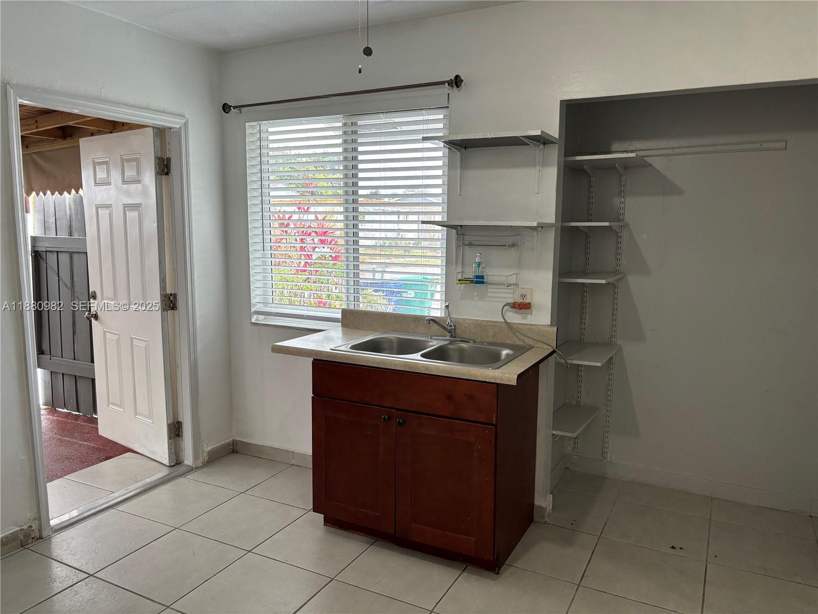 12343 Southwest 195th Terrace Miami, FL 33177 - Photo 24 of 45 a kitchen with a stove and a sink