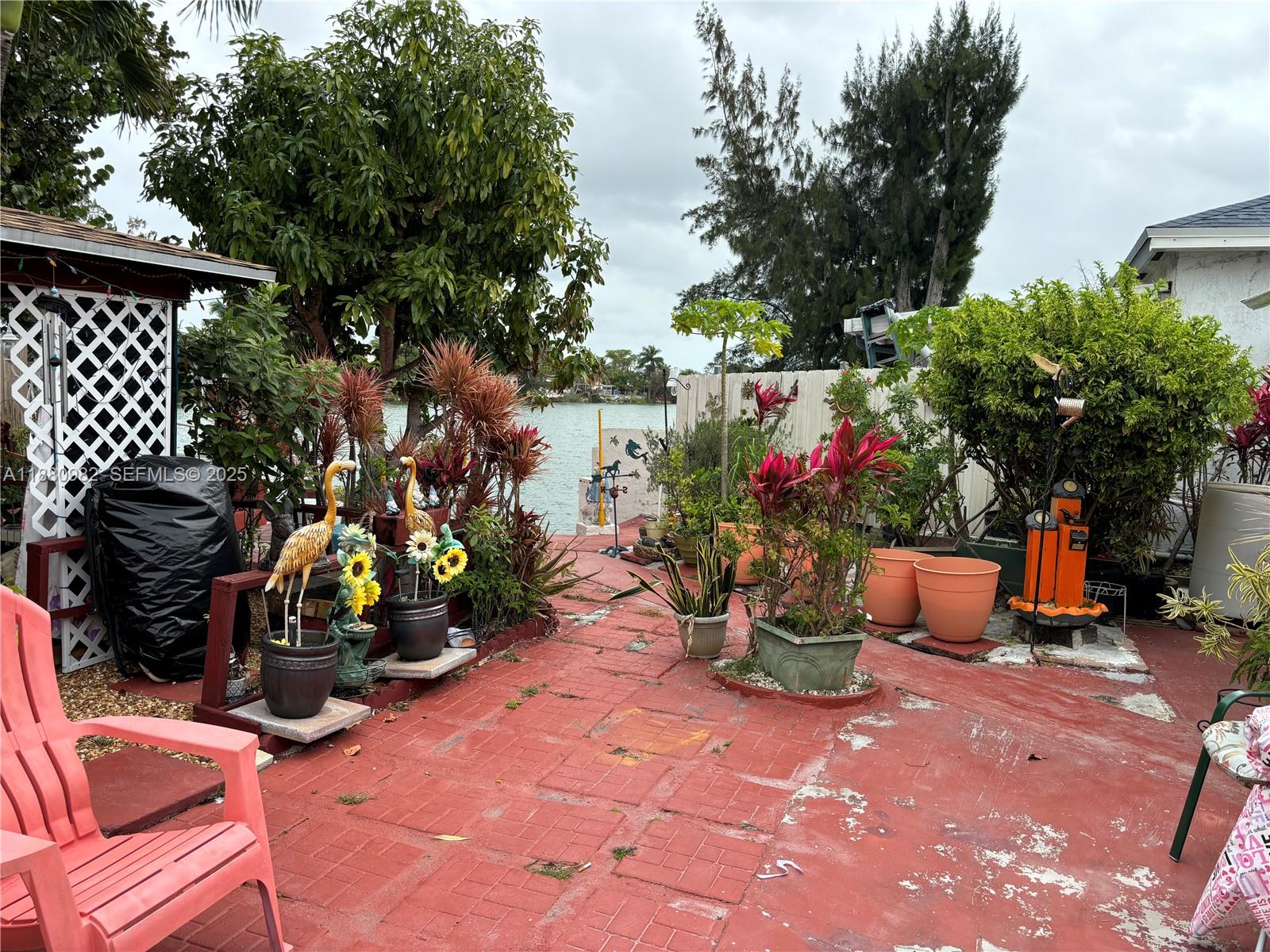 12343 Southwest 195th Terrace Miami, FL 33177 - Photo 36 of 45 a view of a patio with plants and chairs