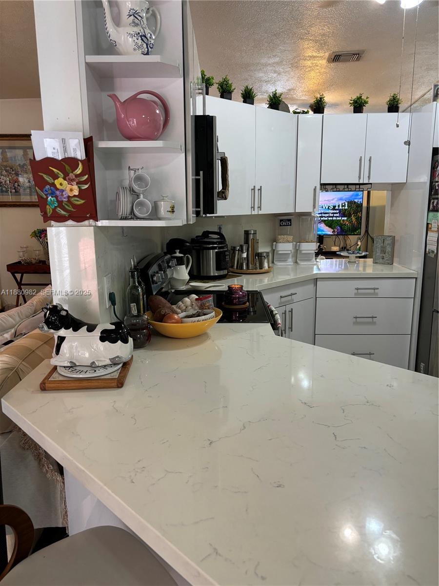 12343 Southwest 195th Terrace Miami, FL 33177 - Photo 44 of 45 a kitchen with a sink a stove and cabinets