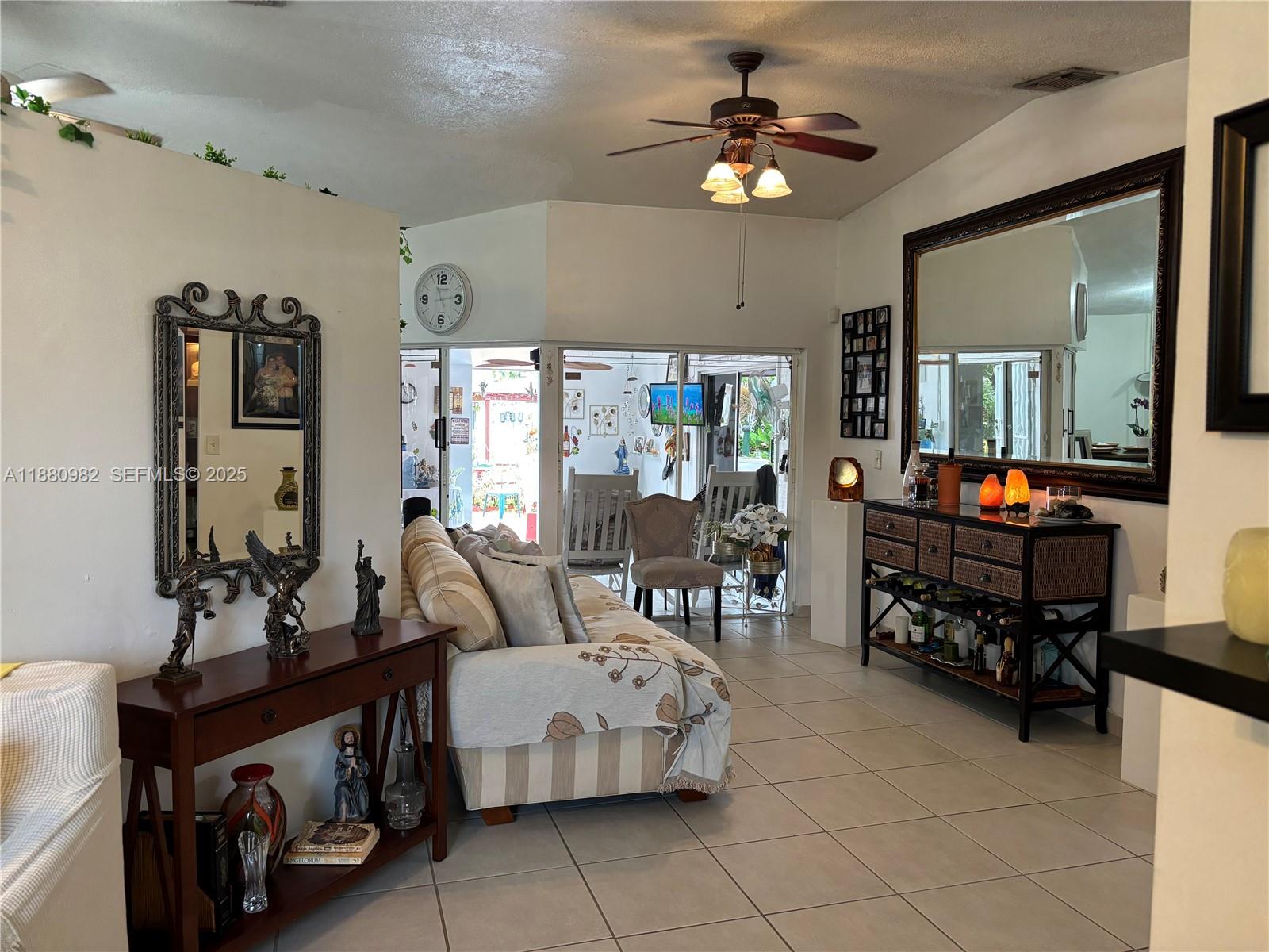 12343 Southwest 195th Terrace Miami, FL 33177 - Photo 5 of 45 a living room with furniture and a chandelier