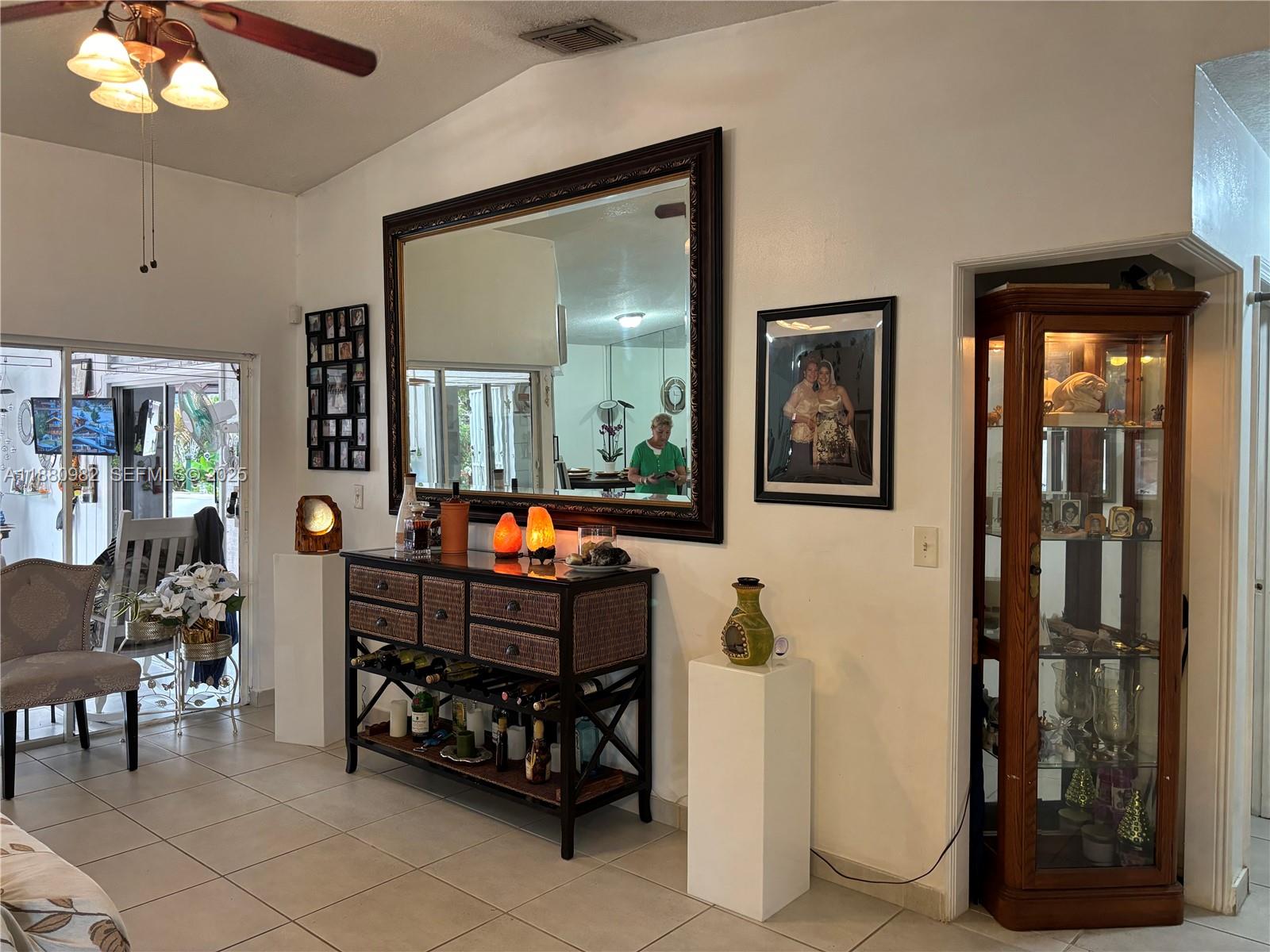 12343 Southwest 195th Terrace Miami, FL 33177 - Photo 7 of 45 a living room with furniture and a mirror