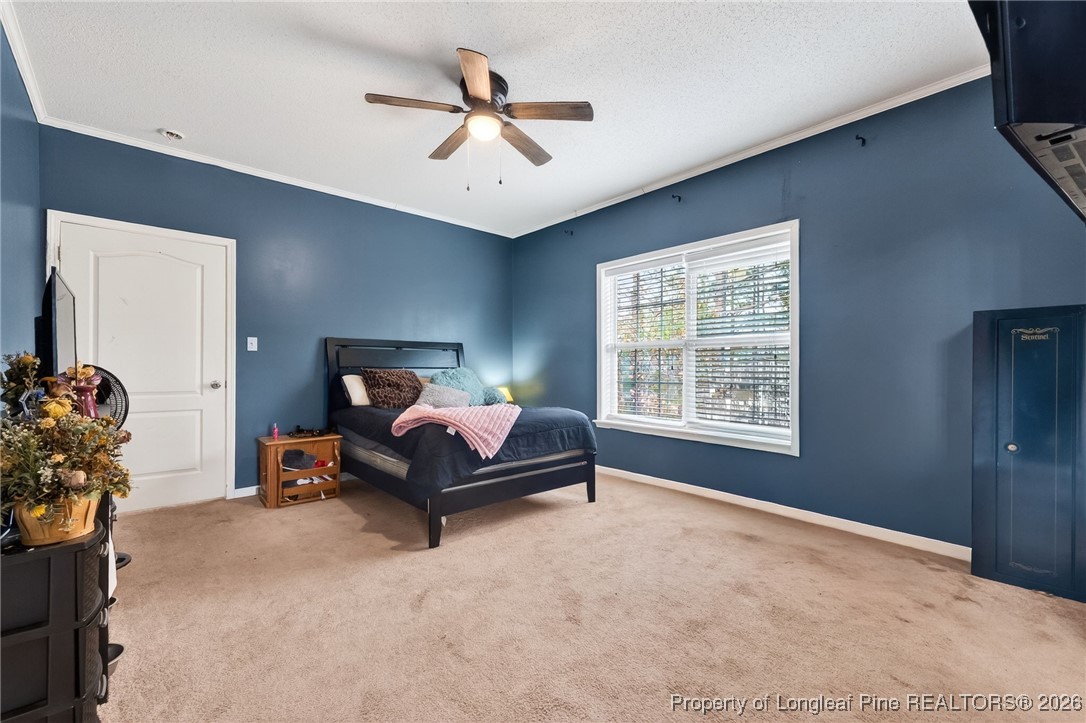 121 Prairie Lane Lillington, NC 27546 - Photo 12 of 40 a bed room with a bed and a chair