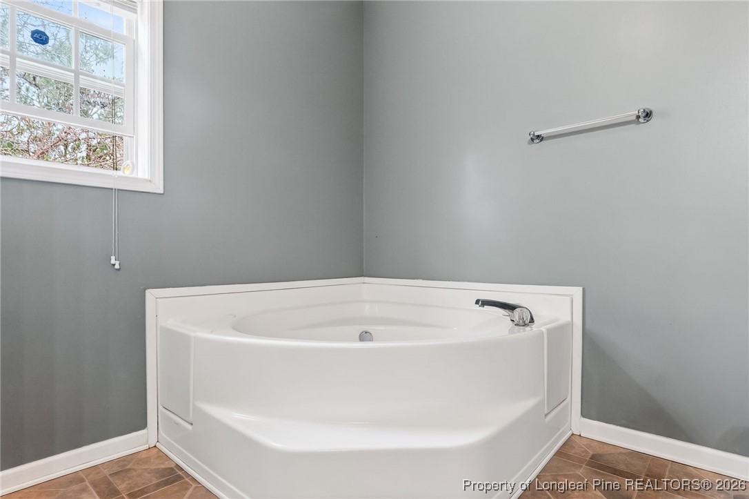 121 Prairie Lane Lillington, NC 27546 - Photo 17 of 40 a white bath tub sitting in a bathroom
