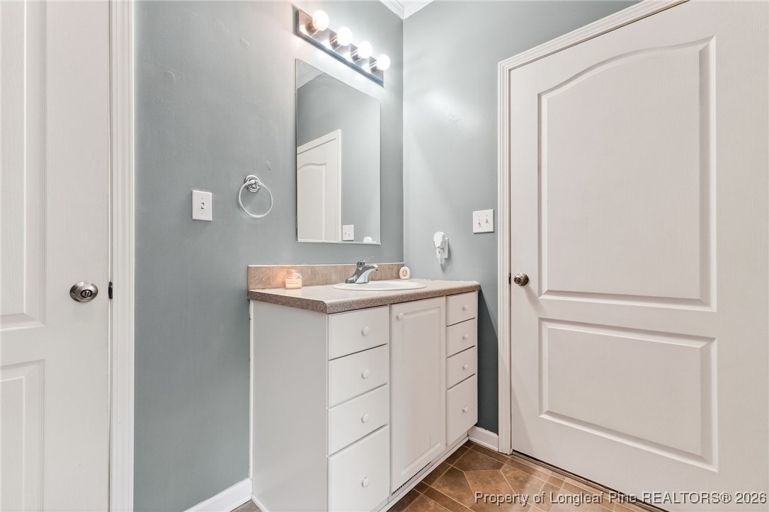 121 Prairie Lane Lillington, NC 27546 - Photo 18 of 40 a bathroom with a sink vanity and a mirror