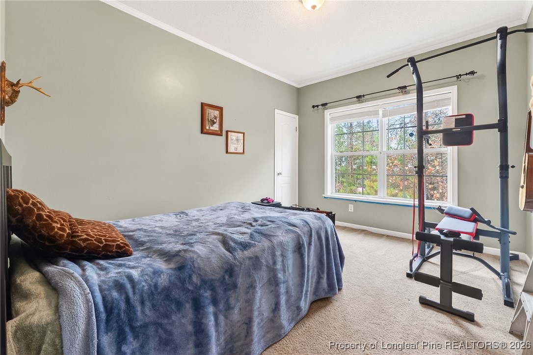 121 Prairie Lane Lillington, NC 27546 - Photo 22 of 40 a bedroom with a bed window and chair