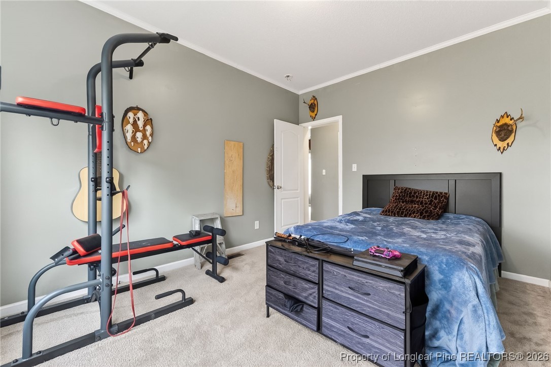 121 Prairie Lane Lillington, NC 27546 - Photo 23 of 40 a bedroom with a bed and a table