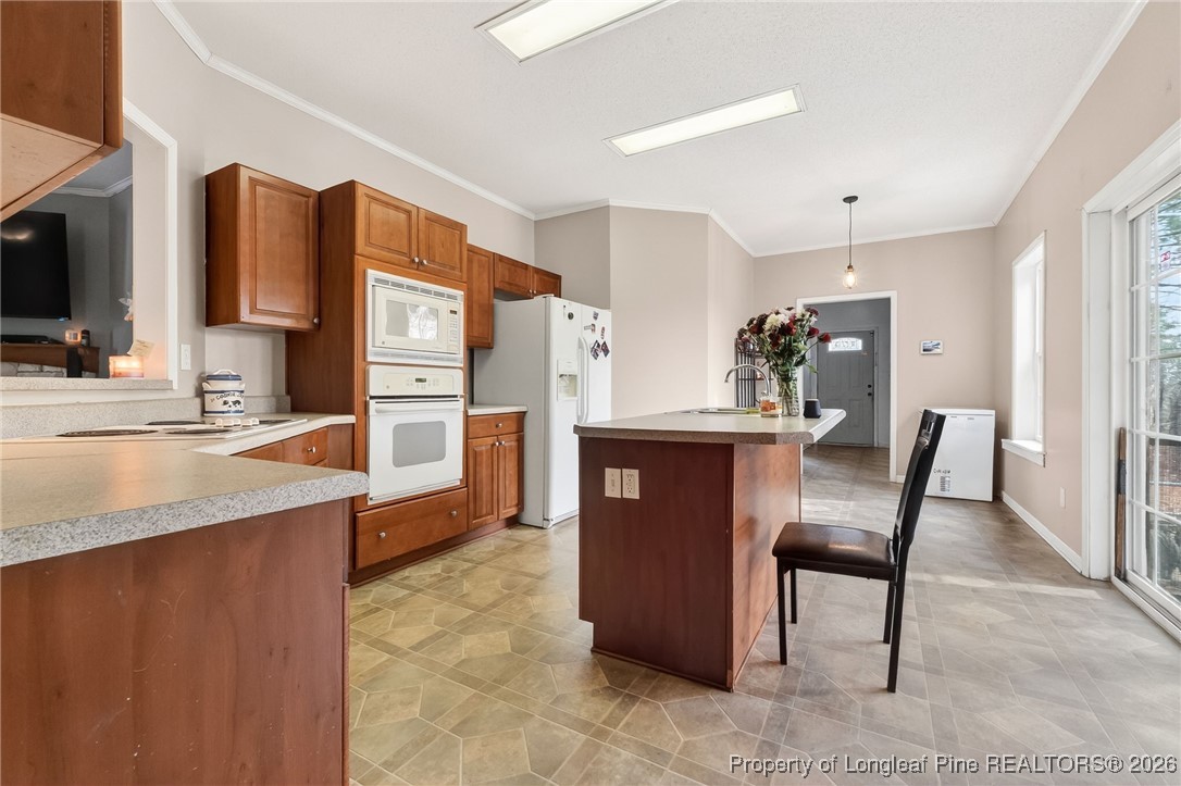 121 Prairie Lane Lillington, NC 27546 - Photo 3 of 40 a kitchen with stainless steel appliances granite countertop a refrigerator and a stove top oven