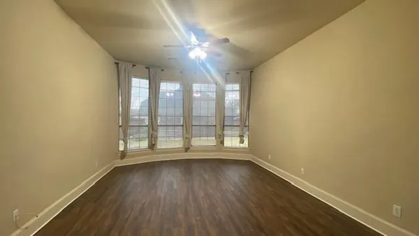 a view of a house with a large window and plants