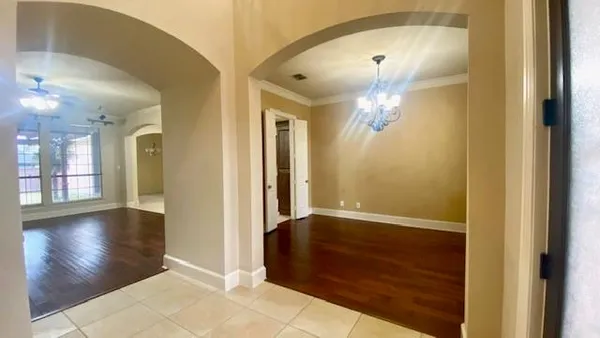 a view of a room with wooden floor and a fireplace