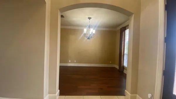 a large hall with stainless steel appliances kitchen island granite countertop a large kitchen island a stove and a sink