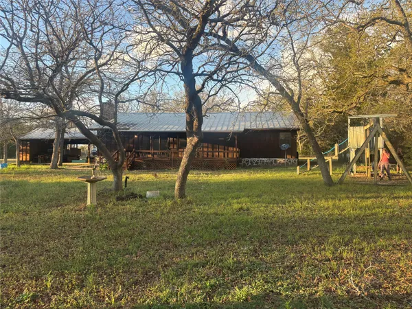 a view of a playground with a tree