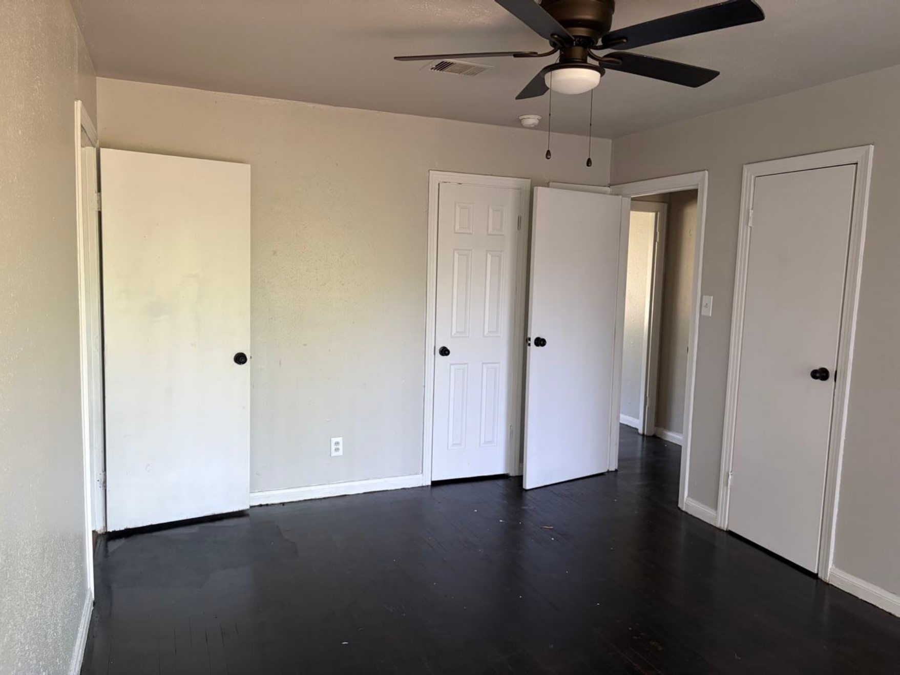 5782 Belcrest Street Houston, TX 77033 - Photo 11 of 18 a view of an empty room with wooden floor