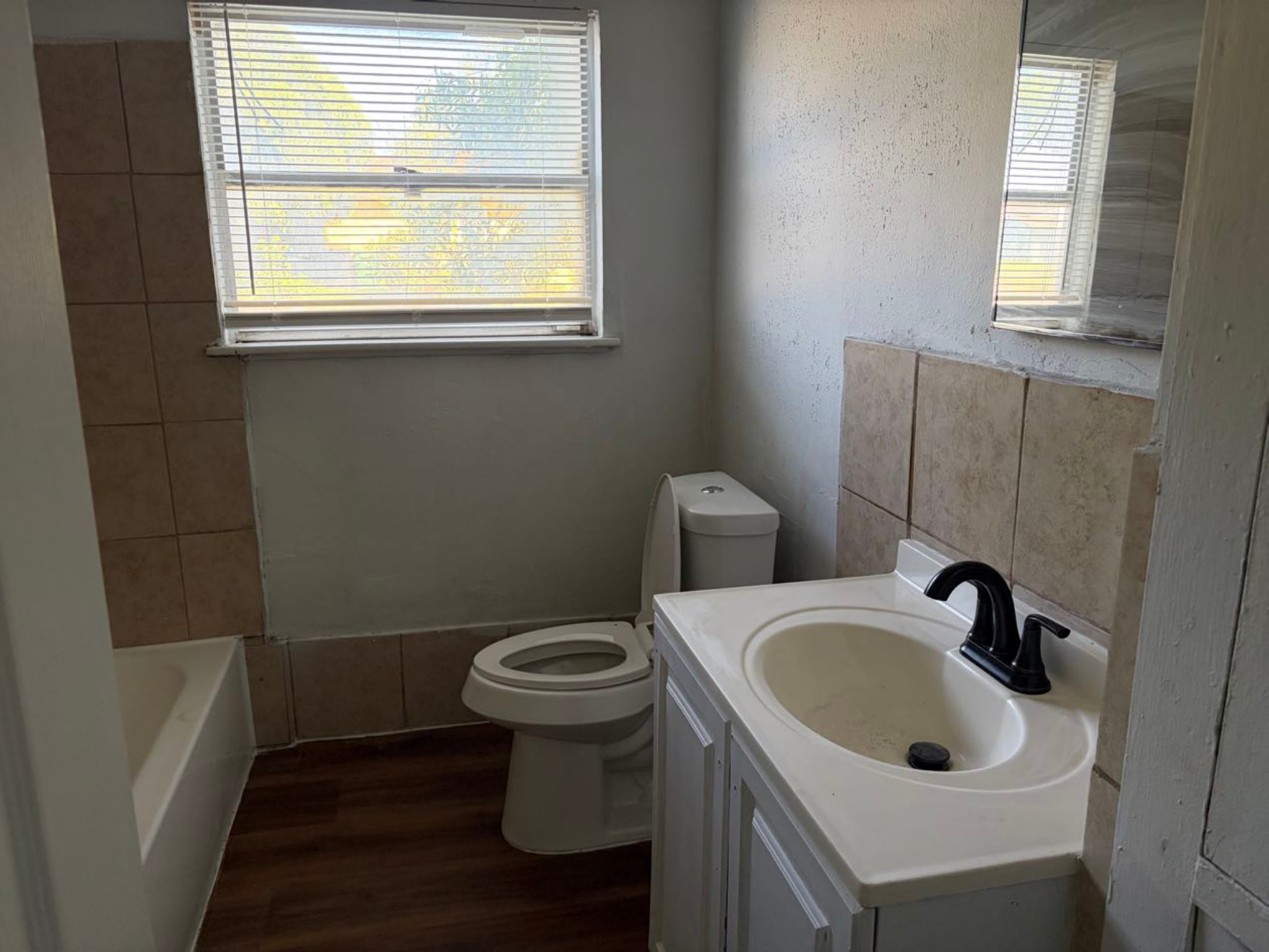 5782 Belcrest Street Houston, TX 77033 - Photo 15 of 18 a bathroom with a sink and a window