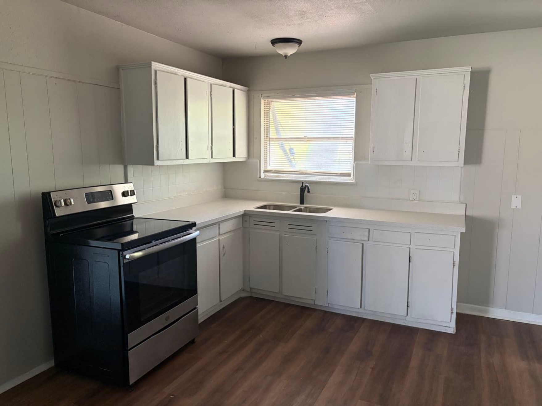 5782 Belcrest Street Houston, TX 77033 - Photo 4 of 18 a kitchen with a sink stove and cabinets