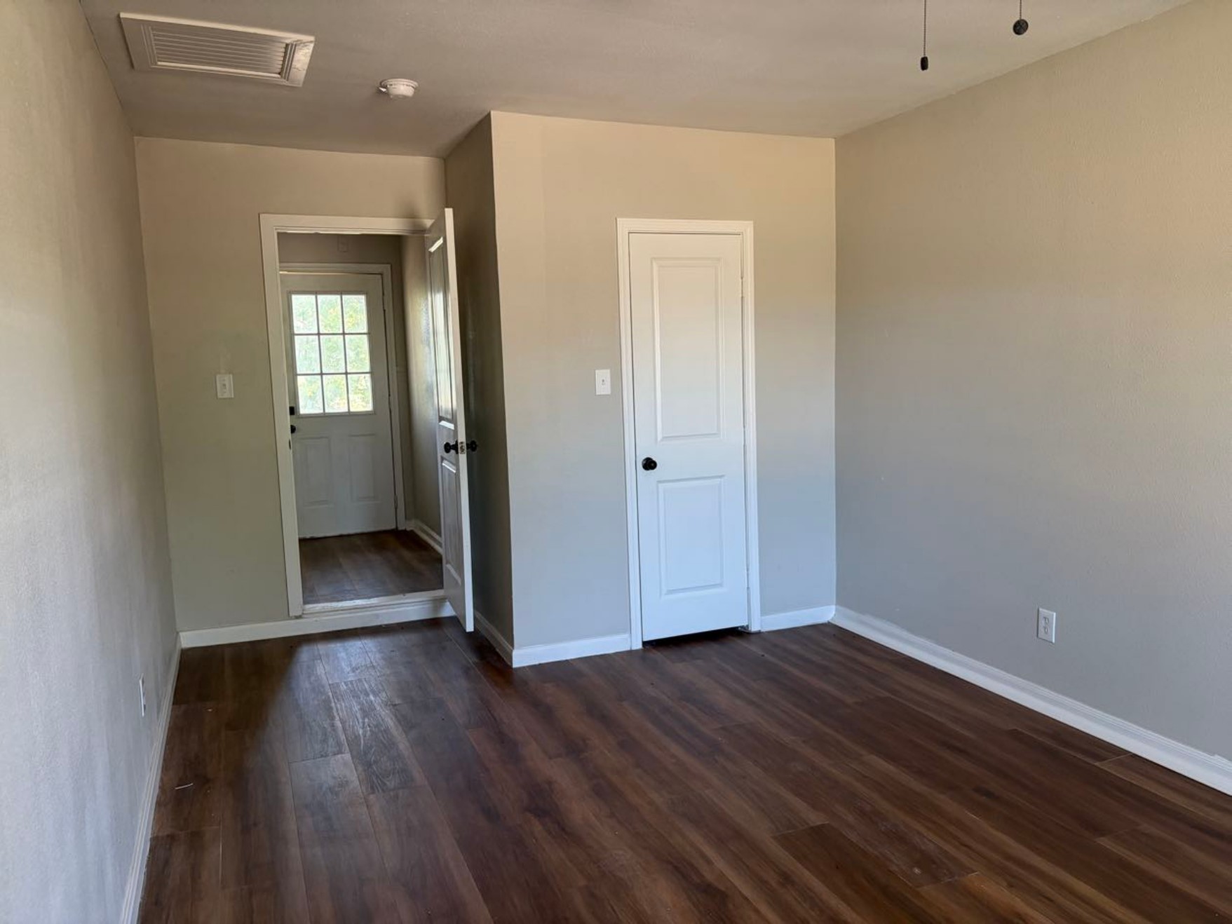 5782 Belcrest Street Houston, TX 77033 - Photo 6 of 18 a view of a hallway with wooden floor