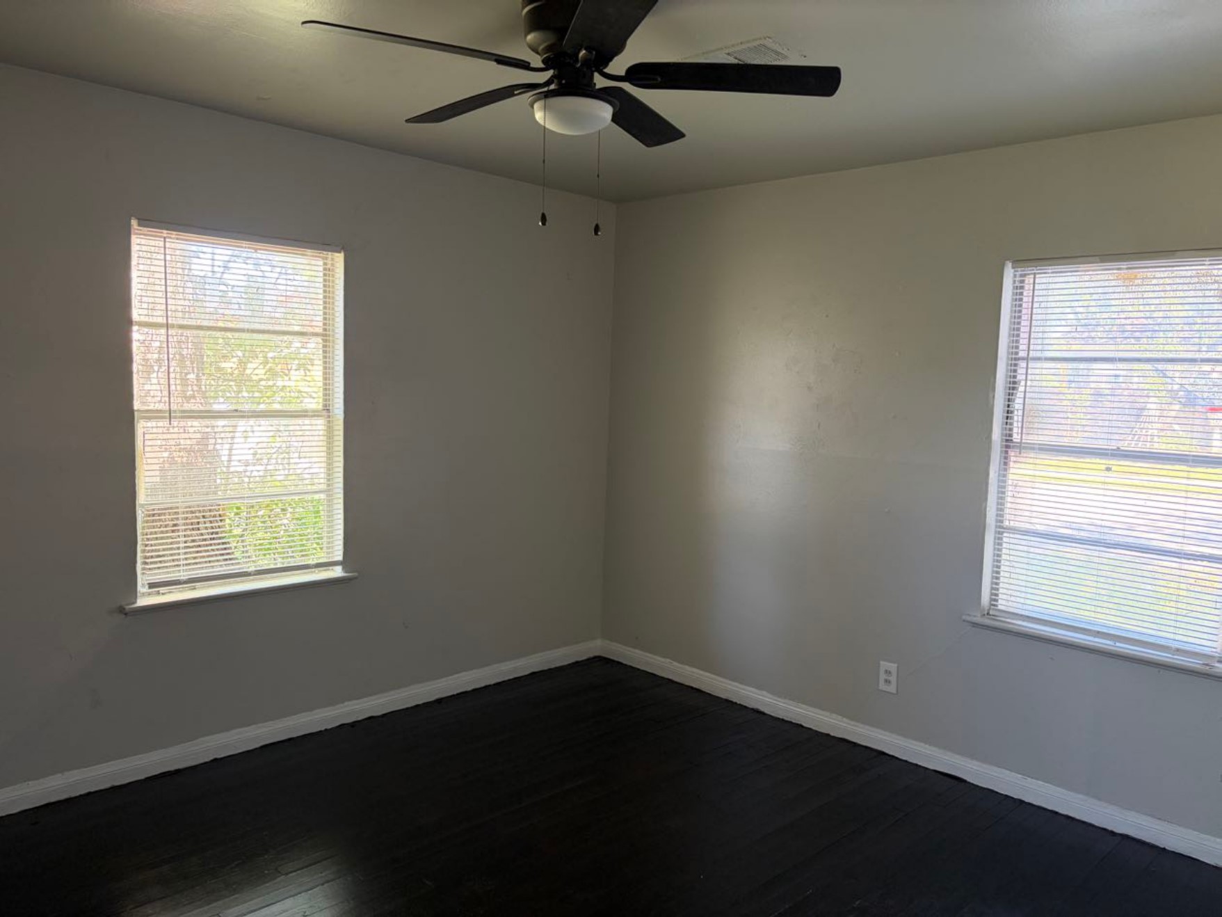 5782 Belcrest Street Houston, TX 77033 - Photo 8 of 18 a view of an empty room with wooden floor and a window