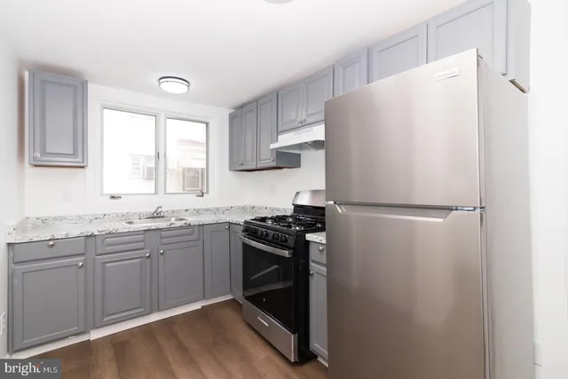 a white refrigerator freezer sitting inside of a kitchen