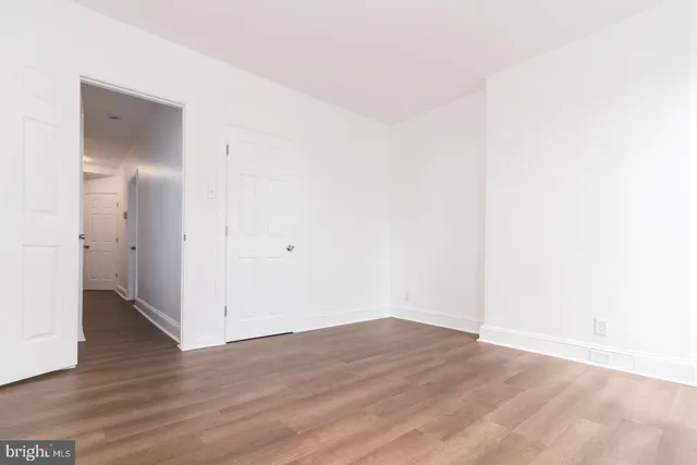 an empty room with wooden floor
