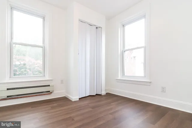 a bathroom with a shower a sink and a window