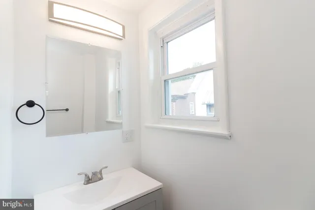 a white toilet sitting next to a sink